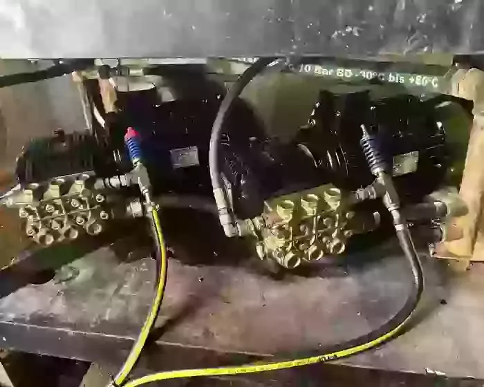 Replacement pumps and motors fitted on a multi-pump pressure washer system during repair work at a malt house in Burton.